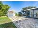 Backyard featuring a stone paver patio, utility shed, covered parking and a screened-in pool area at 3585 Brooklyn Ave, Port Charlotte, FL 33952
