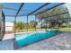 Sparkling pool with screened enclosure and jacuzzi overlooking the backyard at 3585 Brooklyn Ave, Port Charlotte, FL 33952