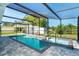 Clean pool with a jacuzzi inside a screened enclosure overlooking the backyard at 3585 Brooklyn Ave, Port Charlotte, FL 33952