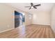 Bright shed interior featuring wood laminate flooring, painted walls, a ceiling fan, and an open doorway at 3585 Brooklyn Ave, Port Charlotte, FL 33952