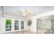 Light filled sun room with sliding glass doors to the exterior and interior at 3585 Brooklyn Ave, Port Charlotte, FL 33952