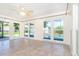 Bright sun room with sliding glass doors that lead to the pool area at 3585 Brooklyn Ave, Port Charlotte, FL 33952