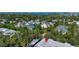 Aerial view of a residential community nestled among lush trees with water views at 3745 Almeria Ave # 7S, Sarasota, FL 34239