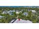 Aerial view of a neighborhood with a lake in the background at 3745 Almeria Ave # 7S, Sarasota, FL 34239