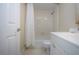 Clean bathroom with white tiled shower, toilet, and vanity with storage at 3745 Almeria Ave # 7S, Sarasota, FL 34239