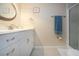 Well-lit bathroom with a white single sink vanity, decorative mirror and tiled floor at 3745 Almeria Ave # 7S, Sarasota, FL 34239