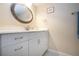 Bathroom vanity with an oval ornate mirror, white cabinetry, and a decorative faucet at 3745 Almeria Ave # 7S, Sarasota, FL 34239