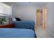 Cozy bedroom featuring twin beds, tile floors, and natural light from a window at 3745 Almeria Ave # 7S, Sarasota, FL 34239