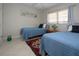 Comfortable bedroom features two twin beds, neutral walls, tile floors and a bright window for natural light at 3745 Almeria Ave # 7S, Sarasota, FL 34239