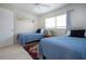 Comfortable bedroom features two twin beds, neutral walls, tile floors and a bright window for natural light at 3745 Almeria Ave # 7S, Sarasota, FL 34239