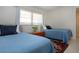 Cozy bedroom featuring two twin beds, closet, and tile flooring at 3745 Almeria Ave # 7S, Sarasota, FL 34239