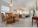 Cozy dining area features a wooden table, four chairs, neutral walls, and a seamless transition to the living room at 3745 Almeria Ave # 7S, Sarasota, FL 34239