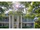 Two-story condominium complex featuring screened in patios, well-manicured lawns, and mature trees at 3745 Almeria Ave # 7S, Sarasota, FL 34239