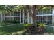 Two-story condominium complex featuring screened in patios, well-manicured lawns, and mature trees at 3745 Almeria Ave # 7S, Sarasota, FL 34239
