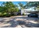 Exterior view of a two-story condo with a screened lanai and a covered parking area at 3745 Almeria Ave # 7S, Sarasota, FL 34239