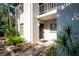 Front entrance to a condo featuring a black front door and tasteful landscaping at 3745 Almeria Ave # 7S, Sarasota, FL 34239