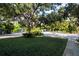 Well-manicured front lawn with mature oak trees offering ample shade at 3745 Almeria Ave # 7S, Sarasota, FL 34239