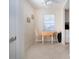Bright breakfast nook features a wood table and chairs, complemented by natural light from the window at 3745 Almeria Ave # 7S, Sarasota, FL 34239