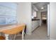Bright breakfast nook features a wood table and chairs, complemented by natural light from the window at 3745 Almeria Ave # 7S, Sarasota, FL 34239