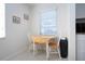 Bright breakfast nook features a wood table and chairs, complemented by natural light from the window at 3745 Almeria Ave # 7S, Sarasota, FL 34239