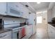 Clean and compact kitchen with white cabinets and appliances at 3745 Almeria Ave # 7S, Sarasota, FL 34239