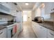 Galley kitchen with granite counters, white cabinets, and modern appliances, offering a functional cooking space at 3745 Almeria Ave # 7S, Sarasota, FL 34239