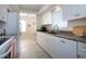 Well-maintained kitchen featuring white cabinets, granite countertops, and tile flooring at 3745 Almeria Ave # 7S, Sarasota, FL 34239