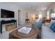 Well-lit living room with cozy furnishings and tiled floors at 3745 Almeria Ave # 7S, Sarasota, FL 34239