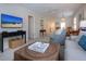 Living room showcasing a media console, flat screen TV, and comfortable seating area at 3745 Almeria Ave # 7S, Sarasota, FL 34239