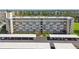 Scenic aerial view of the condo building with covered parking, landscaping and greenery at 3820 Ironwood Ln # 104-I, Bradenton, FL 34209