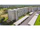 Aerial view of condo building and parking, plus manicured lawn and golf course at 3820 Ironwood Ln # 104-I, Bradenton, FL 34209