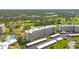 Attractive aerial view of the condo complex, highlighting the pool, parking and lush golf course at 3820 Ironwood Ln # 104-I, Bradenton, FL 34209