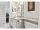 Bright bathroom with a large mirror, vanity, and toilet; entryway is visible at 3820 Ironwood Ln # 104-I, Bradenton, FL 34209