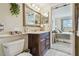 Bathroom featuring a vanity with a mirror, a toilet, and a view into the adjacent bedroom at 3820 Ironwood Ln # 104-I, Bradenton, FL 34209