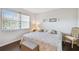 Bright bedroom featuring a cozy bed with floral pillows and coastal decor for a relaxing ambiance at 3820 Ironwood Ln # 104-I, Bradenton, FL 34209