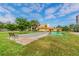 Community bocce court and shuffleboard with benches surrounded by lush landscaping and sunny sky at 3820 Ironwood Ln # 104-I, Bradenton, FL 34209