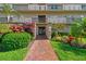 Beautiful building entrance with lush landscaping and a brick walkway at 3820 Ironwood Ln # 104-I, Bradenton, FL 34209