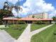 Clubhouse featuring lush landscaping and palm trees at 3820 Ironwood Ln # 104-I, Bradenton, FL 34209