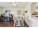 Light-filled dining room with hardwood floors offering a view of the living area at 3820 Ironwood Ln # 104-I, Bradenton, FL 34209