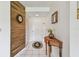 Stylish entryway featuring wood accent wall, tile floors, and decorative table at 3820 Ironwood Ln # 104-I, Bradenton, FL 34209