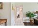 Hallway featuring tile flooring, a decorative plant, and access to other rooms within the home at 3820 Ironwood Ln # 104-I, Bradenton, FL 34209
