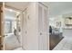 Hallway featuring white tile, a closet, and entryways into adjacent rooms with natural light at 3820 Ironwood Ln # 104-I, Bradenton, FL 34209