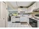 Bright kitchen with tile floors and white cabinets is conveniently open to the living room at 3820 Ironwood Ln # 104-I, Bradenton, FL 34209