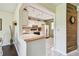 Compact kitchen with white cabinets and vintage appliances at 3820 Ironwood Ln # 104-I, Bradenton, FL 34209
