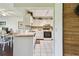 Well-lit kitchen with white cabinetry adjacent to a dining area at 3820 Ironwood Ln # 104-I, Bradenton, FL 34209