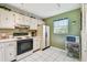 Bright kitchen with white appliances, a window, and lots of storage at 3820 Ironwood Ln # 104-I, Bradenton, FL 34209