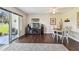 Inviting living room featuring a cozy rug, flat screen TV, and access to an outdoor patio with scenic views at 3820 Ironwood Ln # 104-I, Bradenton, FL 34209