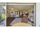 Inviting living room with ample natural light and cozy seating arrangement with hardwood flooring and sliding glass doors at 3820 Ironwood Ln # 104-I, Bradenton, FL 34209