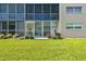 Lovely screened-in patio, perfect for enjoying the outdoors, with outdoor furniture and a view of the grassy yard at 3820 Ironwood Ln # 104-I, Bradenton, FL 34209
