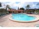 Community pool surrounded by lounge chairs and tables, perfect for relaxation and socializing at 3820 Ironwood Ln # 104-I, Bradenton, FL 34209